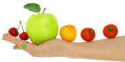 Female hand with a row of fresh colorful fruits